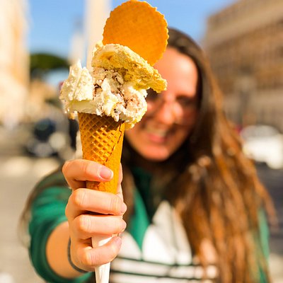 A woman showing her gelato ice cream in Rome 