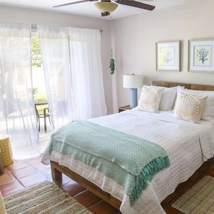 Villa Montana Beach Resort in Puerto Rico, image may contain: Home Decor, Bed, Furniture, Bedroom