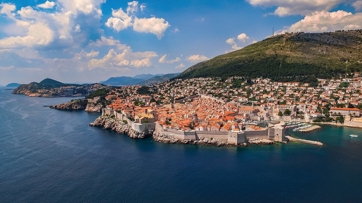 Aerial view of Dubrovnik's red-roofed buildings and surrounding sea