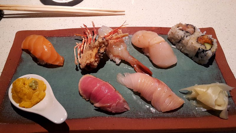 A plate of several different sushi options