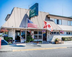 Quality Inn Port Angeles - Near Olympic National Park in Port Angeles, image may contain: Flag, Hotel, Bench, Plant