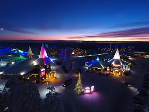 Santa Claus Holiday Village in Rovaniemi, image may contain: Lighting, Hotel, Purple, Night