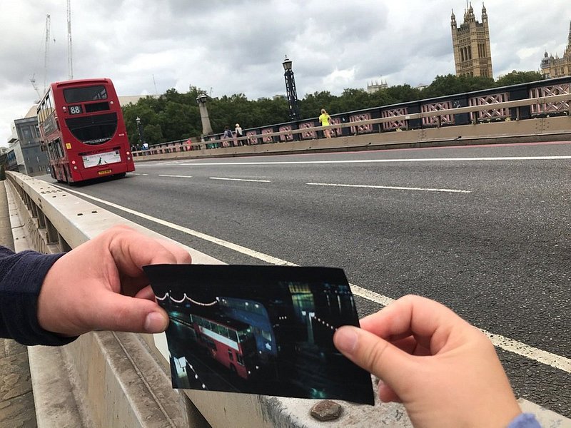 A person holding a photograph in London