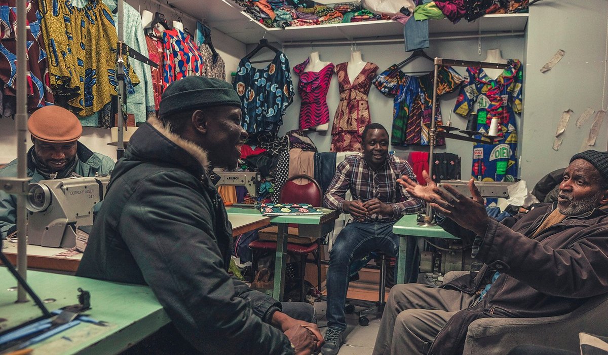 Men from the various former French colonies in Africa congregate for work and conversation in an African garment shop in the Chateau Rouge section of the city also known as Little Africa near the Marcadet