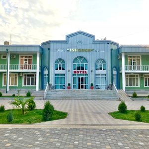 Hotel facade is made in oriental Soviet style. Location in quite area with many trees and roses near