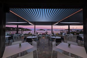 Alkyon Hotel Skiathos in Skiathos, image may contain: Restaurant, Dining Table, Table, Plant