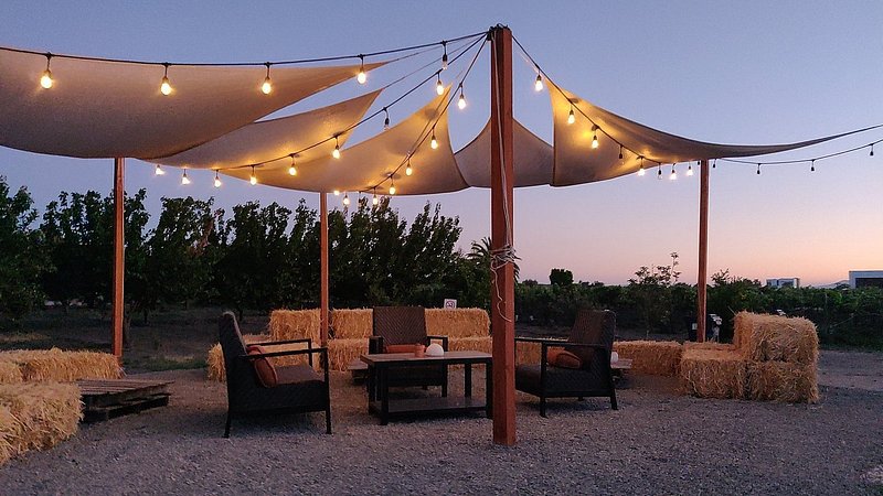 Outdoor seating with string lights at Campera Hotel Burbuja in Valle de Guadalupe, Mexico