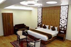 Hotel Shivoy Grand in Varanasi, image may contain: Interior Design, Chair, Home Decor, Resort