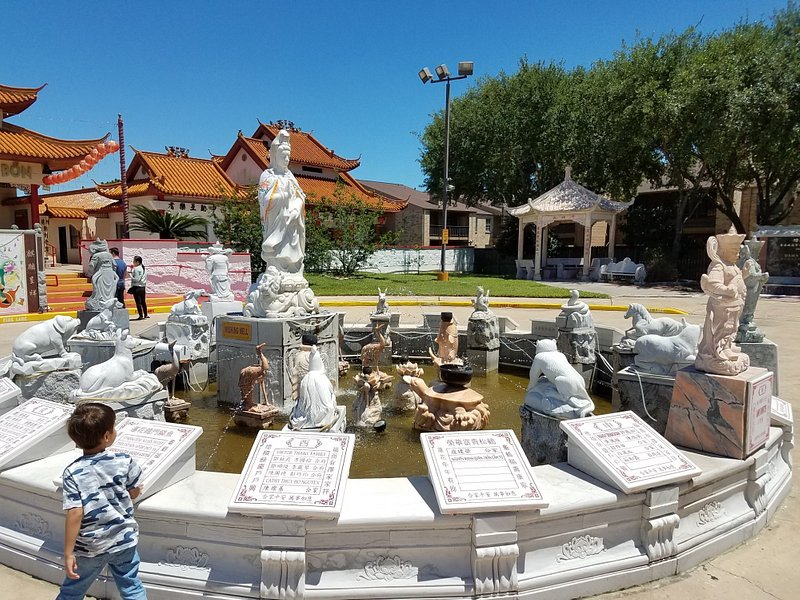 Outdoor fountain filled with various stone sculptures