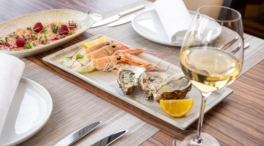 Cold appetizers - prawn carpaccio with dried raspberries and oysters.