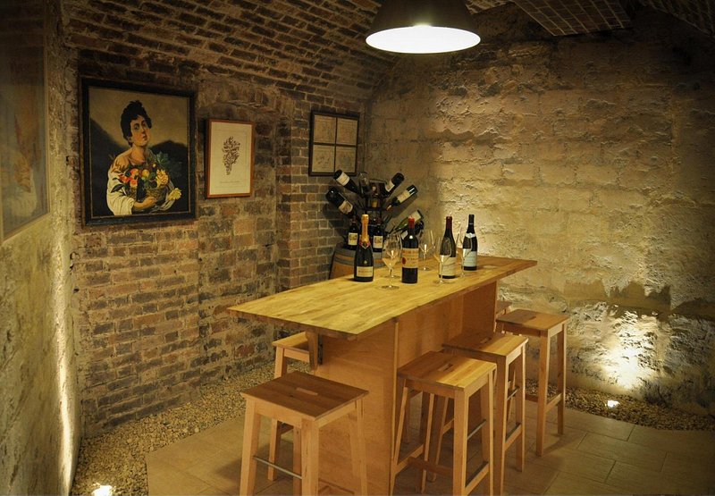 Bottles of wine on a wooden table at La Cave du Sénat – Duval & Blanchet in Paris 