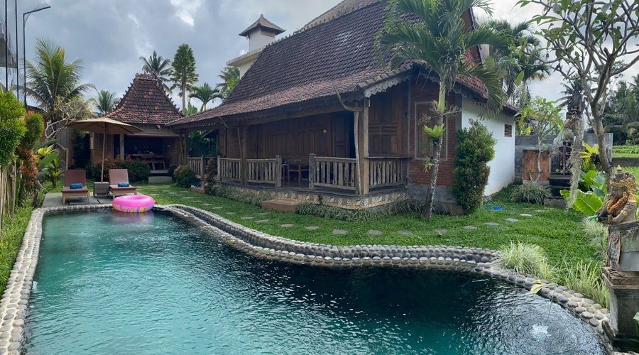 Two large bed rooms with adjacent big bathrooms in the building to the right, kitchen area in the back and a nice pool with view over the rice fields.