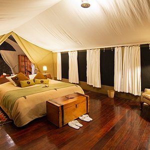 Our tents are en-suite and furnished with a large comfortable bed, Persian rugs and a cozy armchair giving you the ultimate in camping luxury. 