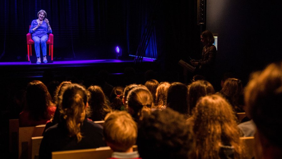 An audience in the interactive Survivor Stories Experience holographic theater.