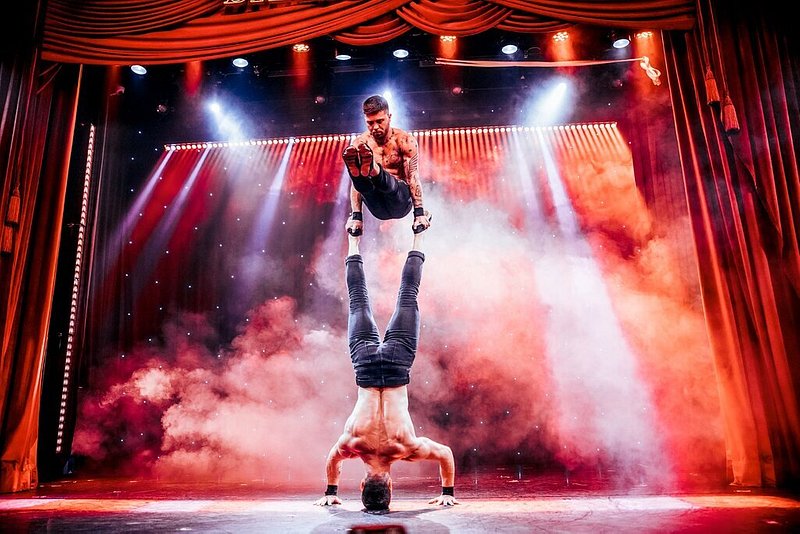 Two male performers performing acrobatics at Billionaire Dubai