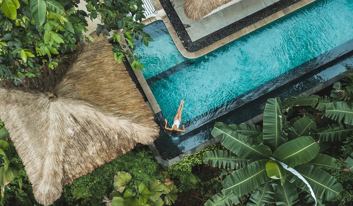 Aerial view of a woman relaxing in a pool in Bali, Indonesia