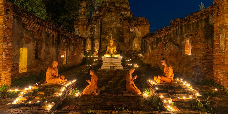 Vipassana meditation in front of Buddha statue in Thailand