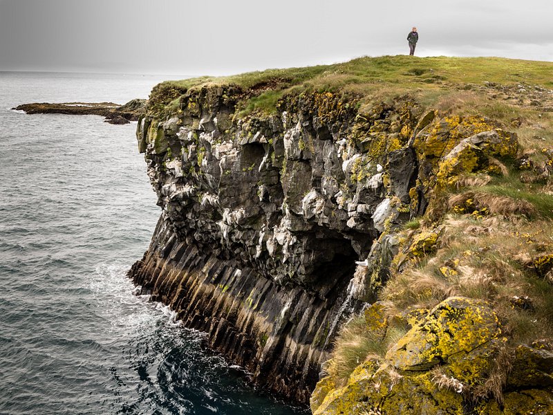 A person standing on a cliff at Snaefellsnes Peninsula in Iceland