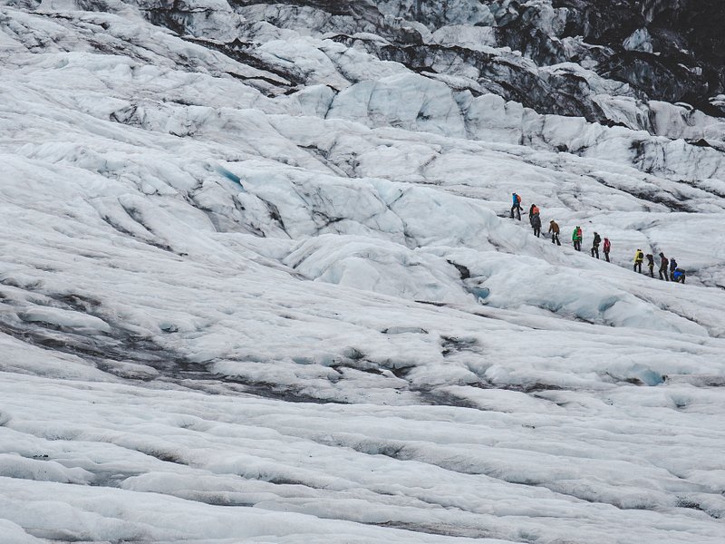 A group of people embarking on a glacier hike in Iceland
