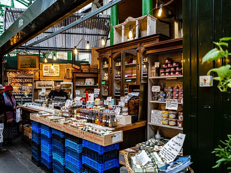 People visiting a shop at the Borough Market in London