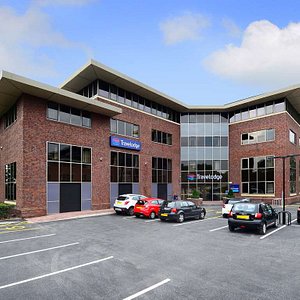 Travelodge Manchester Sale in Sale, image may contain: Office Building, Car Dealership, Car, Neighborhood
