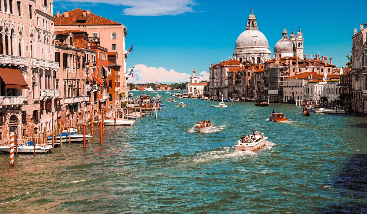Gondolas riding on the canal in summer in Venice