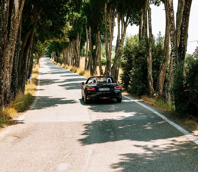 A car driving down the roads in the Tuscan countryside