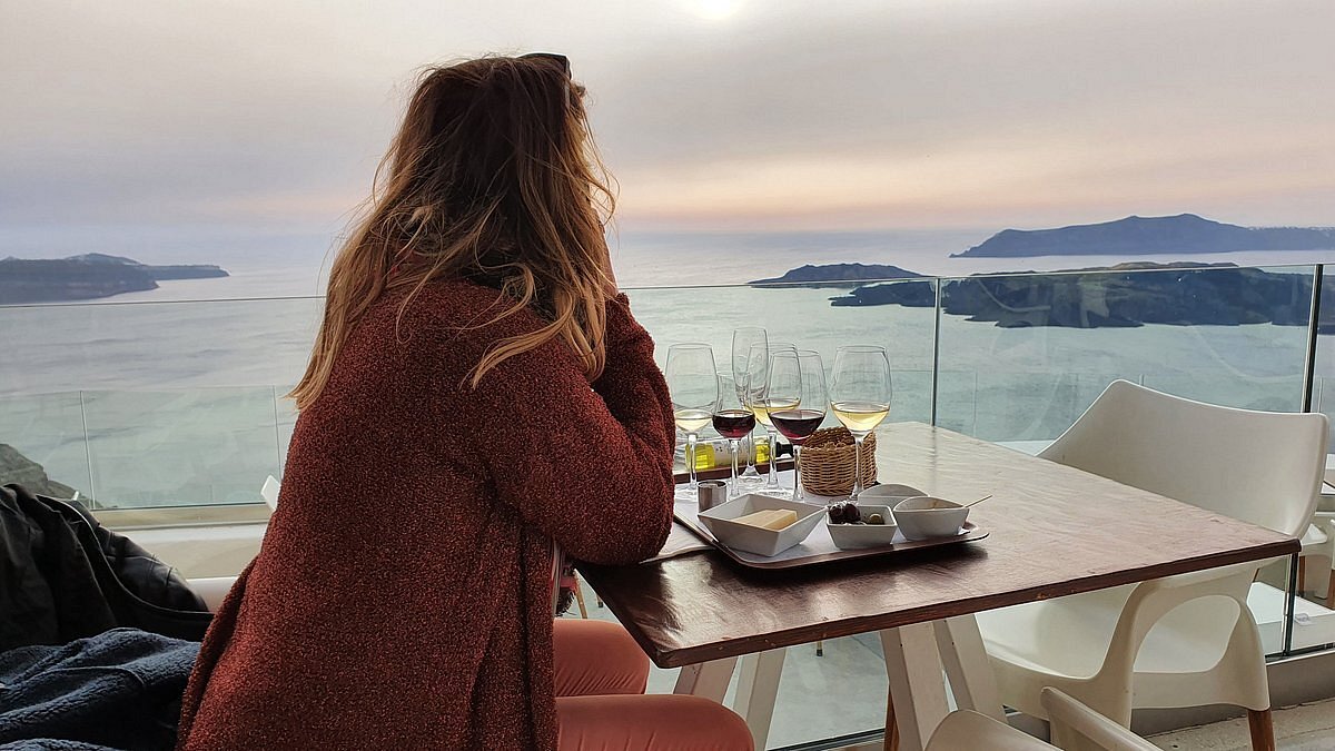 A woman drinking wines at Santo Winery in Santorini