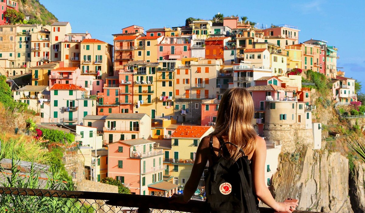 A woman looking out at the scenery in Manarola, Riomaggiore, Italy