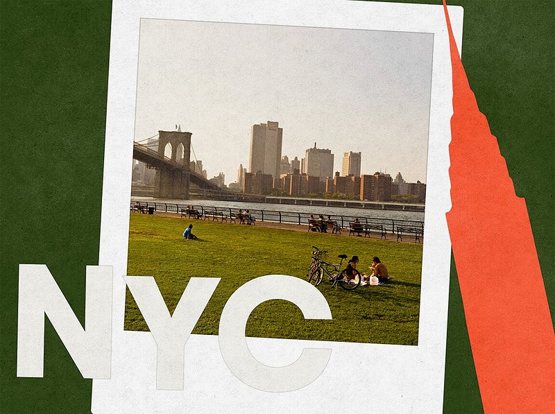 People sitting in Brooklyn Bridge Park overlooking Manhattan