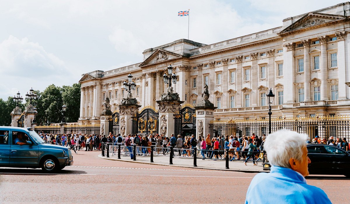 A man standing outside Buckingham Palace in London, England