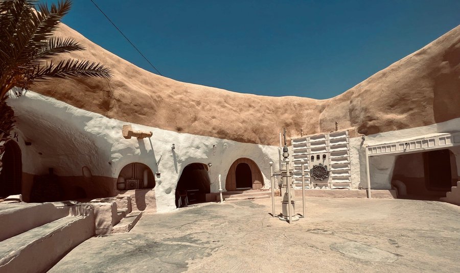 Beautiful view of Hotel Sidi Driss showcasing its unique troglodyte architecture with interconnected courtyards dug into the earth