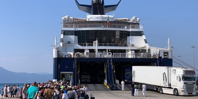 A group of travelers boarding a cruise from Athens to Santorini.