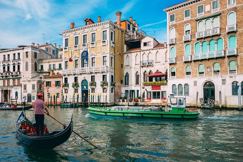 A man rowing a gondola at Venice in Italy