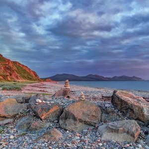 Evening view of sea, Hill and mountains over the rocks, with some pebble art
