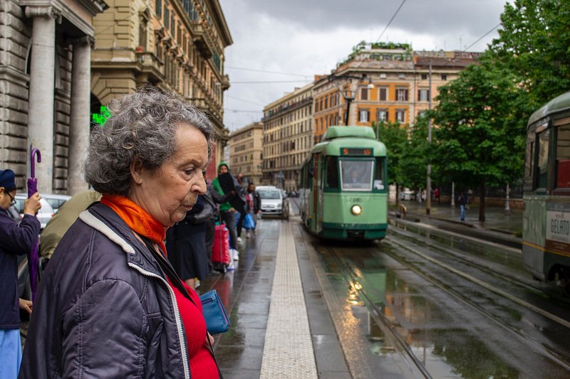 Woman waiting for a tram in Rome, Italy