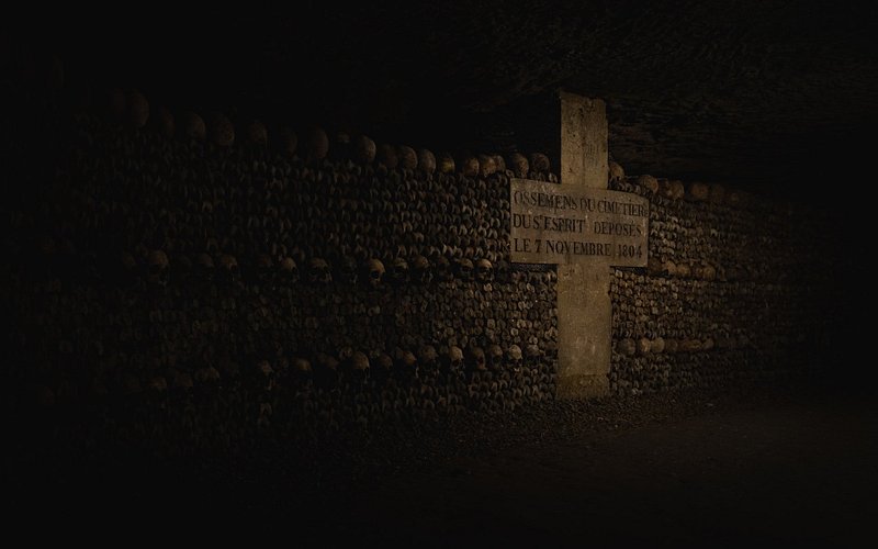 Skulls and signage at the Paris Catacombs