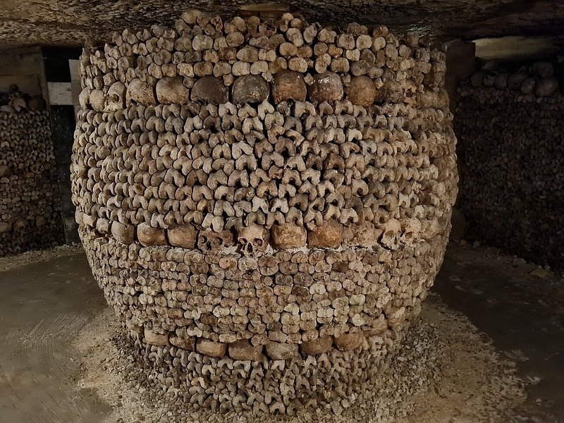 Skulls arranged into a pillar in the Paris Catacombs