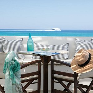 Feel the Greek Summer in your private veranda. Honeymoon Junior Suite, direct sea view.