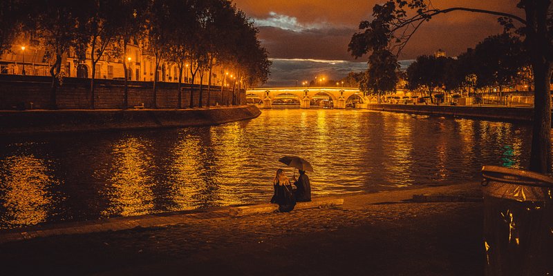 A couple watching the sun set at Seine River.