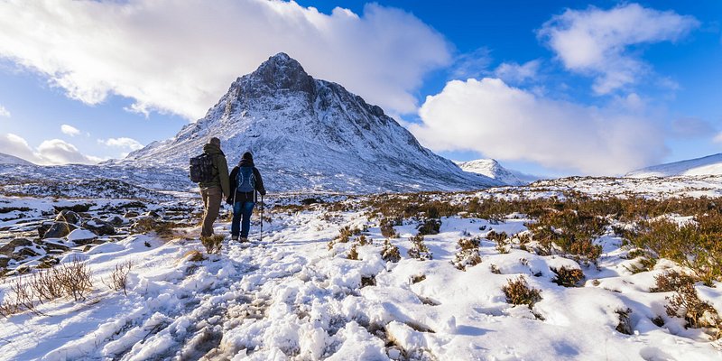 Two people hiking a trail in Glencoe, Scotland
