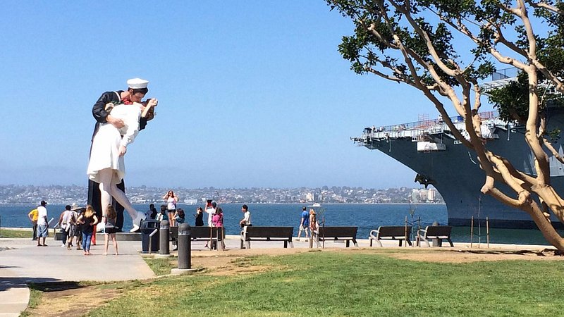 Group of people looking at the Unconditional Surrender statue 