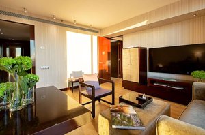 Hyatt Regency Barcelona Tower in Barcelona, image may contain: Living Room, Interior Design, Book, Monitor