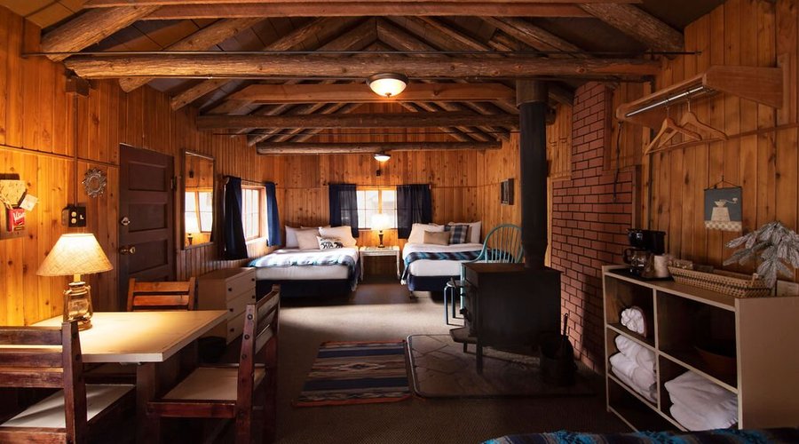 Rustic Cabin #11 has 4 double beds and a wood burning stove.  Access to shower house & bathrooms.  Accommodates up to 8 people.