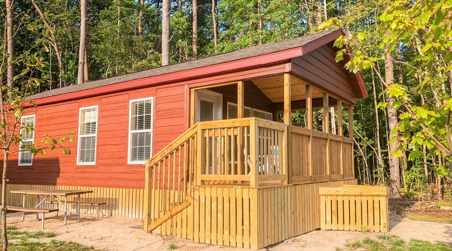 Deluxe Cottage has queen bed, two twin bunk beds, sleeper sofa, full kitchen, private bathroom.