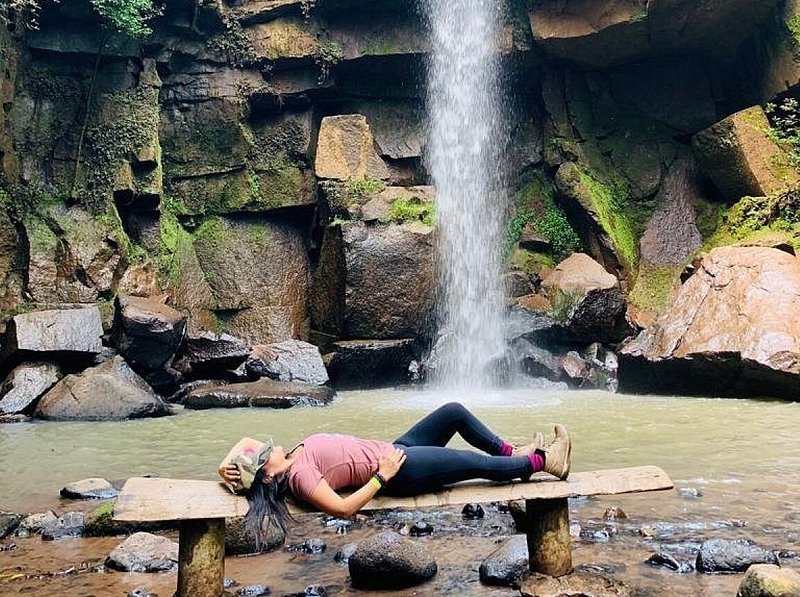 Image of woman laying in front of a waterfall in Mexico