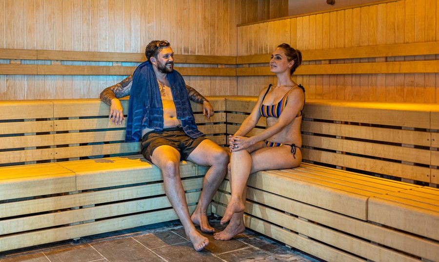 Couple relax in the sauna at the Wellness Suite at Seal Bay Resort