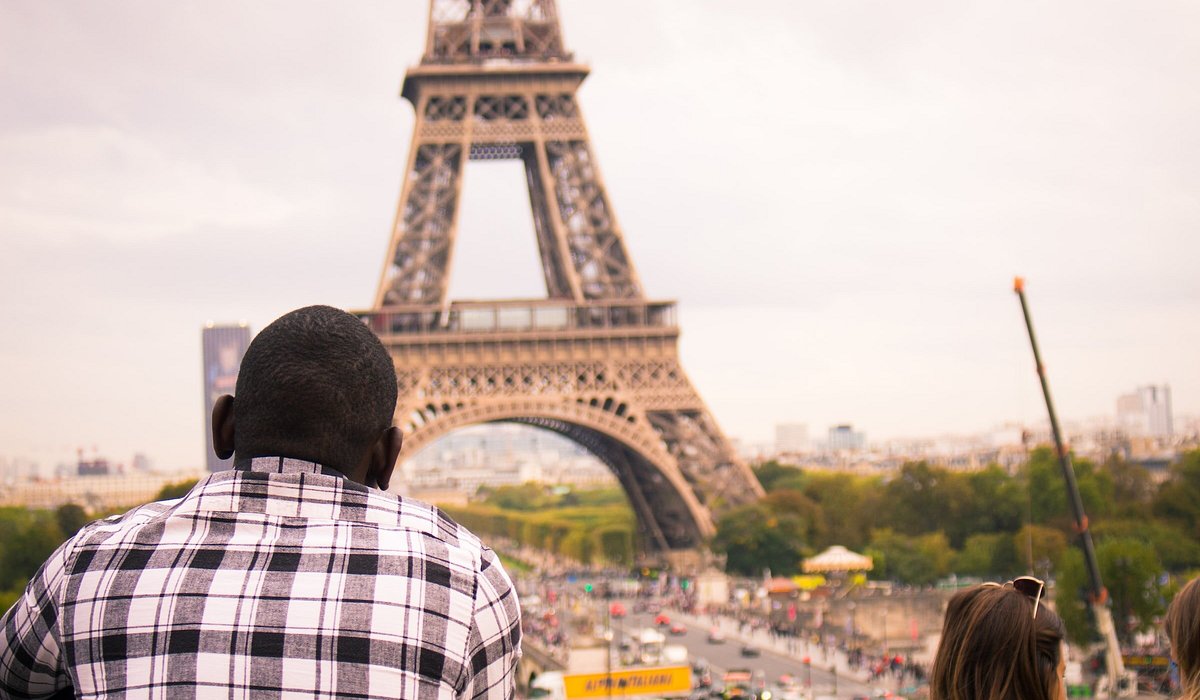 A man admiring the view of the Eiffel Tower in Paris