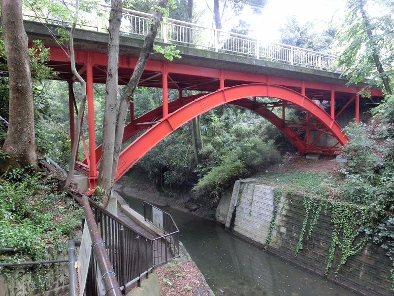 Red bridge spanning across a valley