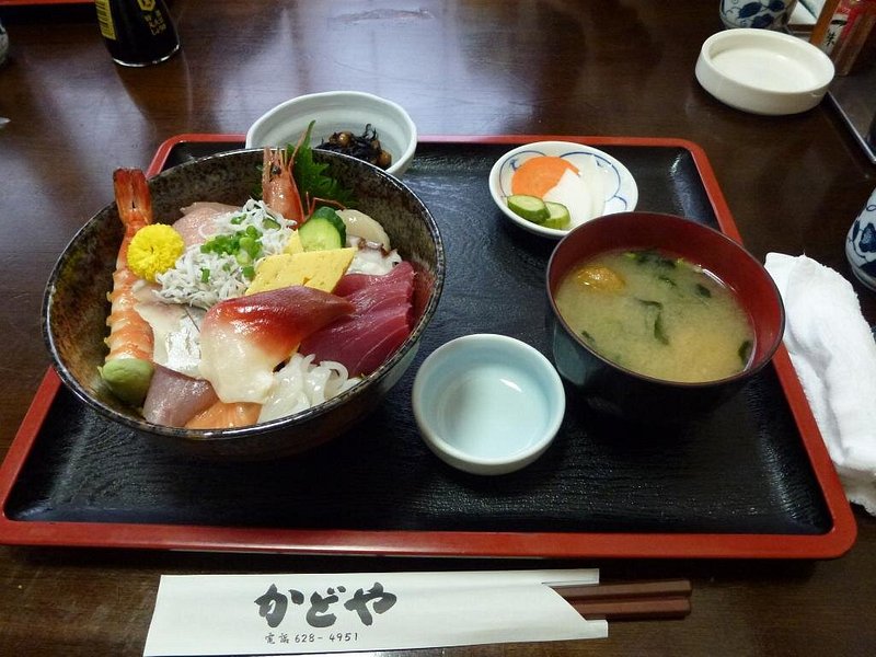 A tray of sashimi don and multiple side dishes